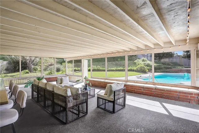 a balcony with furniture and a swing