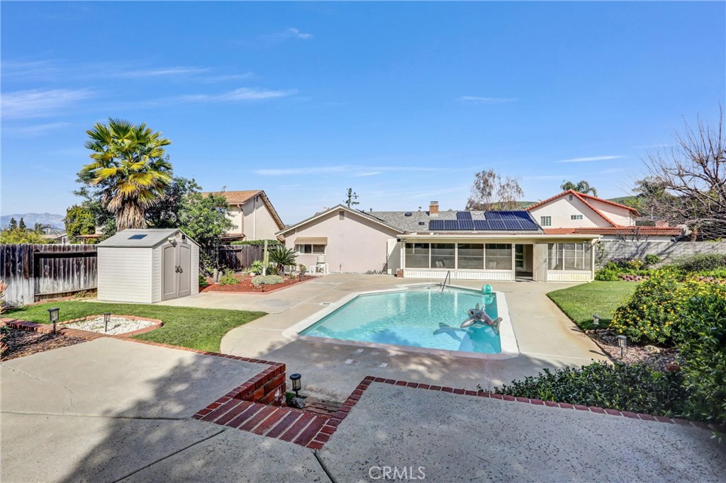 1103 Moonlight Summit Drive Diamond Bar, CA 91765 - Photo 28 of 31 True backyard oasis featuring a pool, large patio, shed storage, and mountain views in the distance.