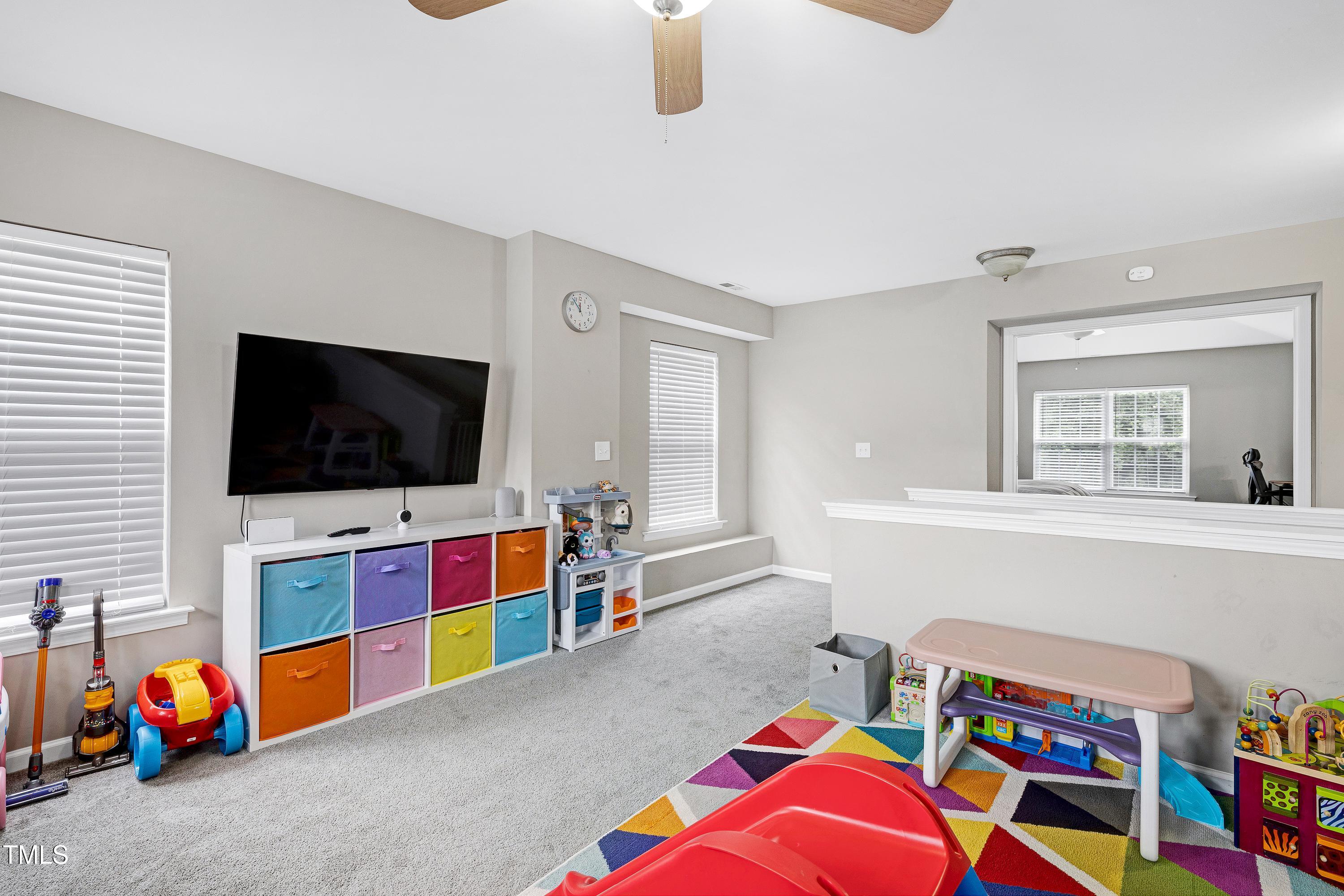 5428 Meryton Park Way Raleigh, NC 27616 - Photo 14 of 29 a living room with furniture and a flat screen tv
