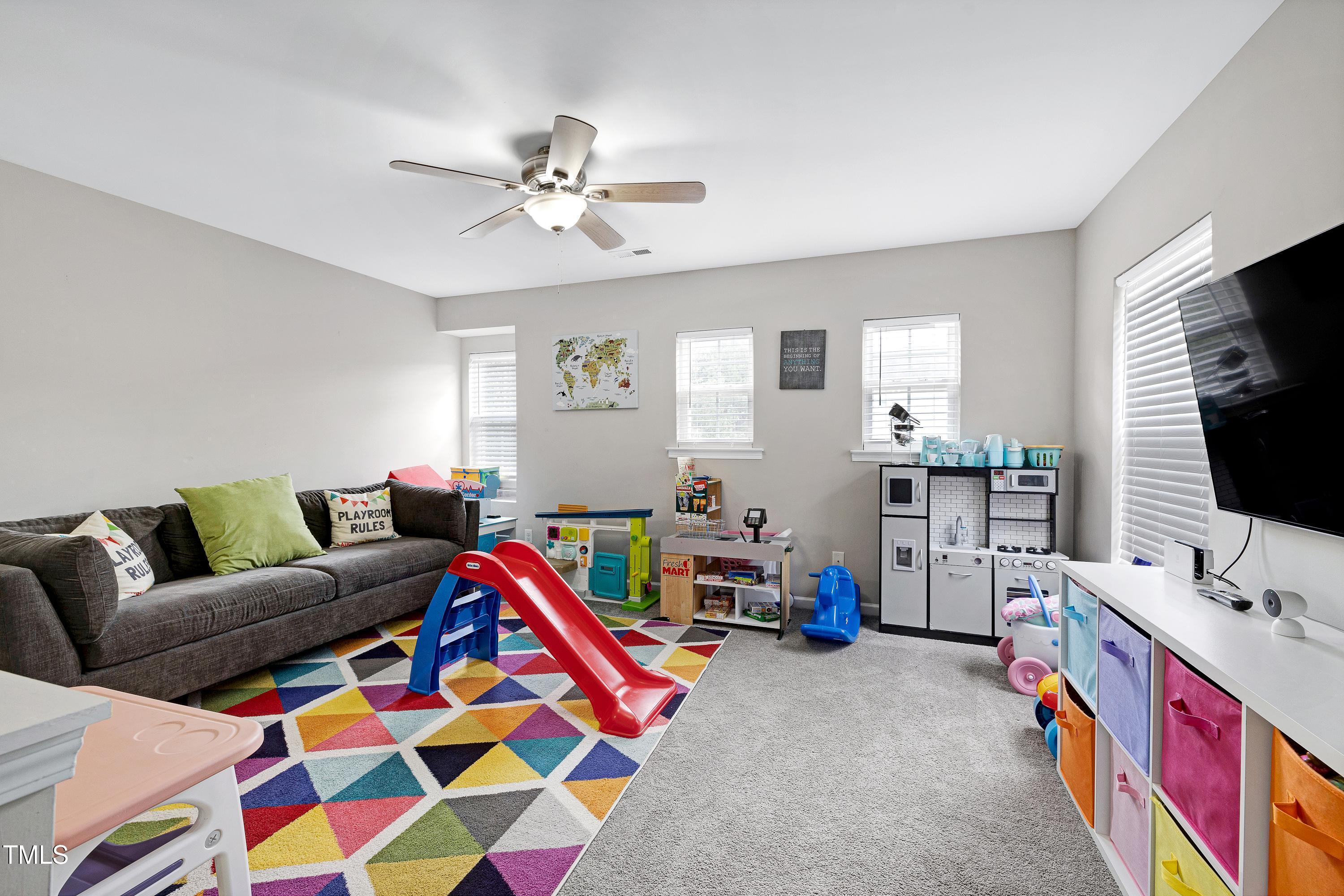 5428 Meryton Park Way Raleigh, NC 27616 - Photo 15 of 29 a living room with furniture and a flat screen tv