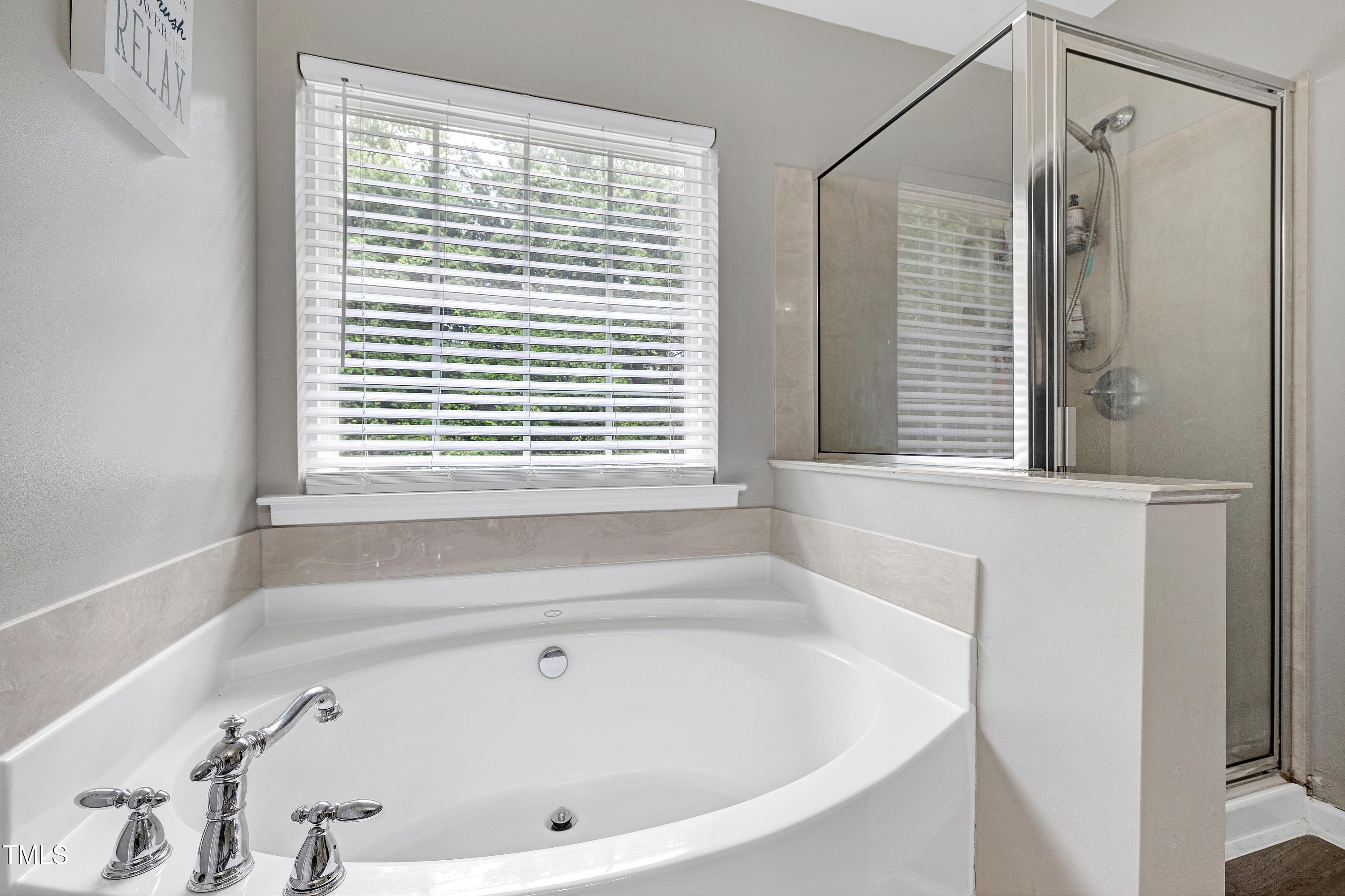 5428 Meryton Park Way Raleigh, NC 27616 - Photo 22 of 29 a bathroom with a bathtub and a window