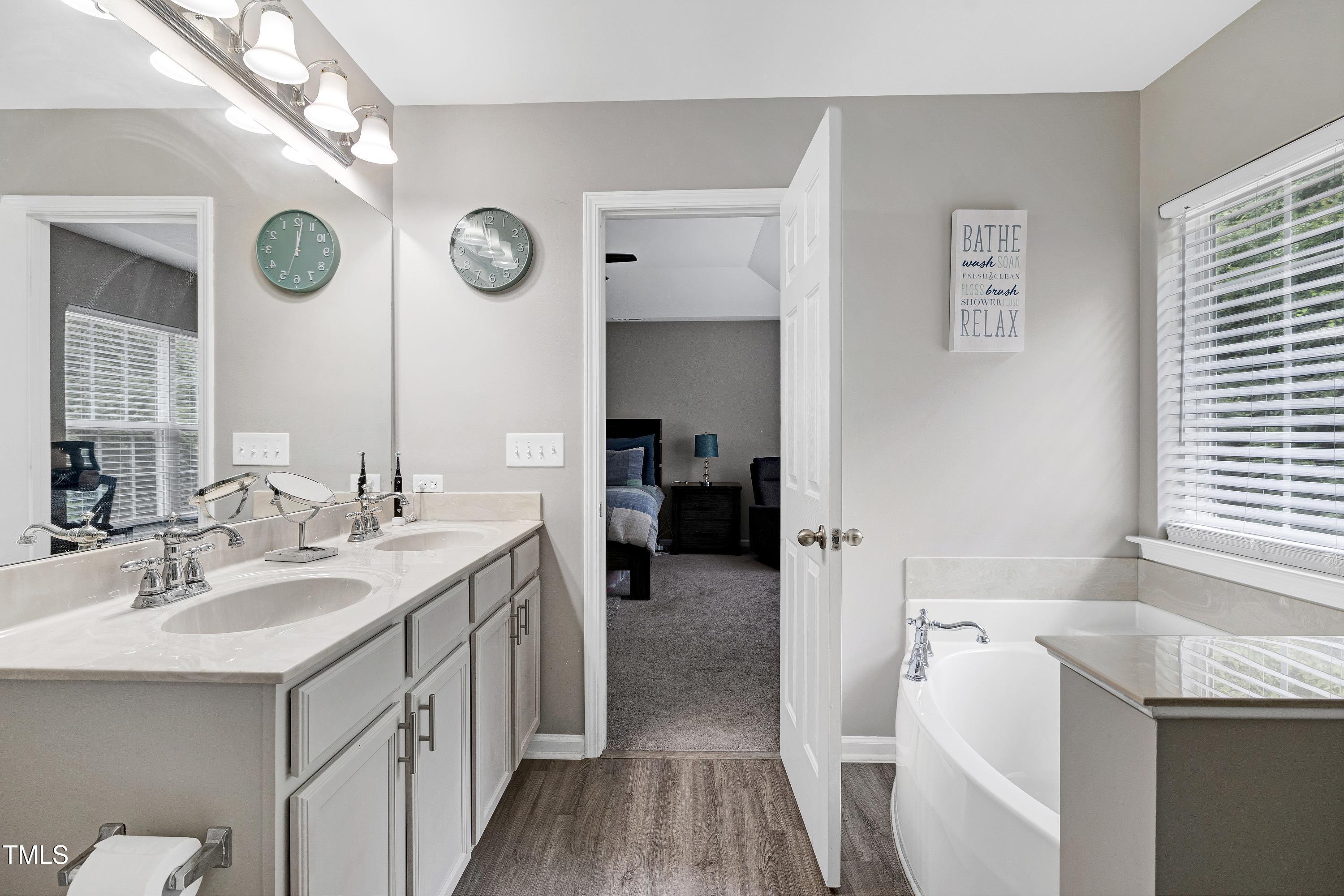 5428 Meryton Park Way Raleigh, NC 27616 - Photo 23 of 29 a en suite bathroom with a sink and a mirror