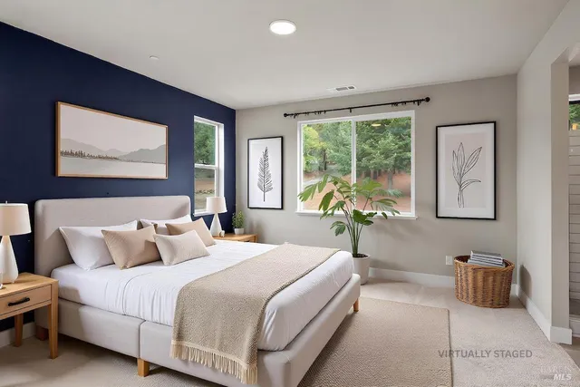 a bedroom with a bed and a large window