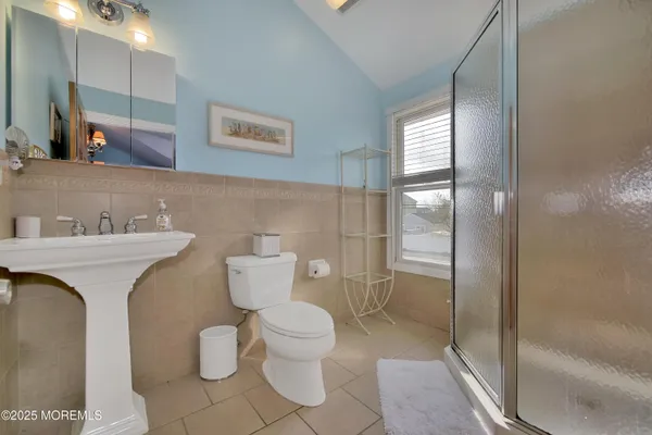 a bathroom with a toilet sink and shower