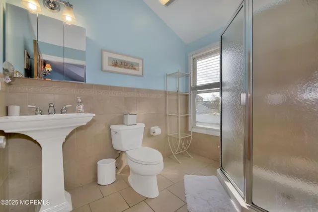 a bathroom with a toilet sink and shower