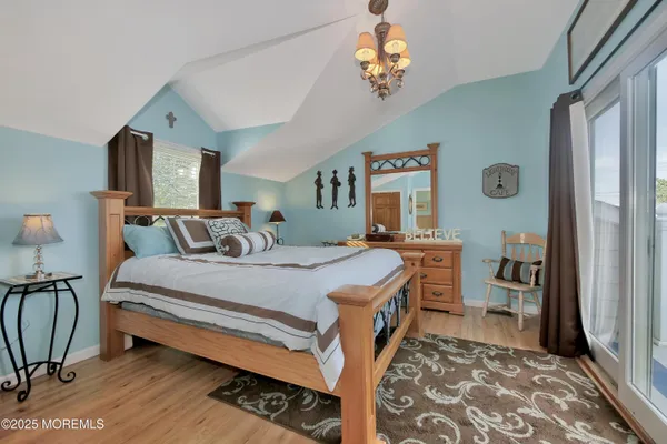 a bed room with a bed and a chandelier