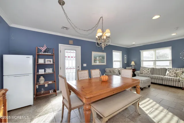 a living room with furniture a chandelier furniture and a window