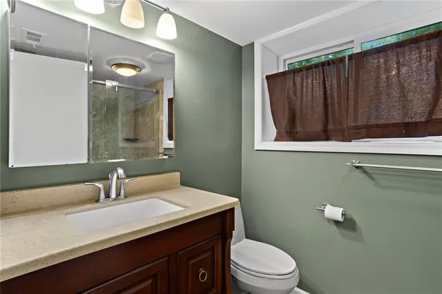 a kitchen with a sink and chairs