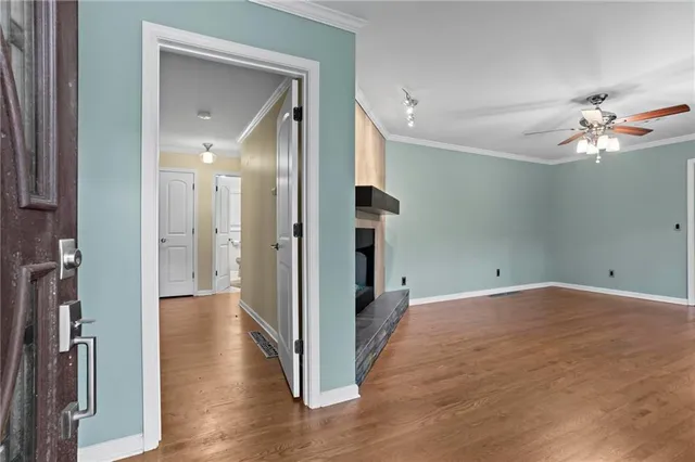 wooden floor in an empty room with a bathroom