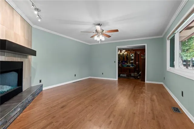 wooden floor in an empty room with a window