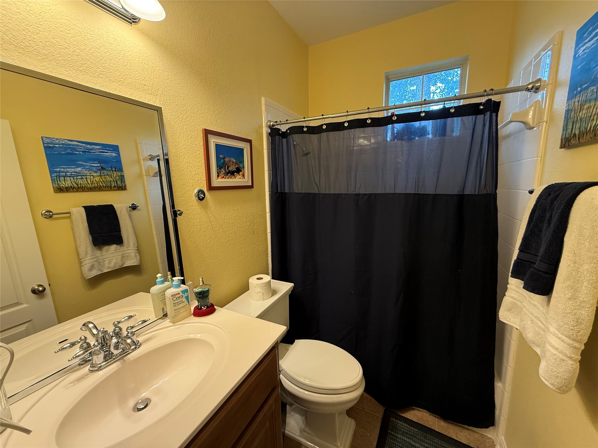 11000 Anderson Mill Road, Unit 93 Austin, TX 78750 - Photo 13 of 27 A well-appointed bathroom features a single vanity, ample mirror space, and a shower with a privacy curtain.