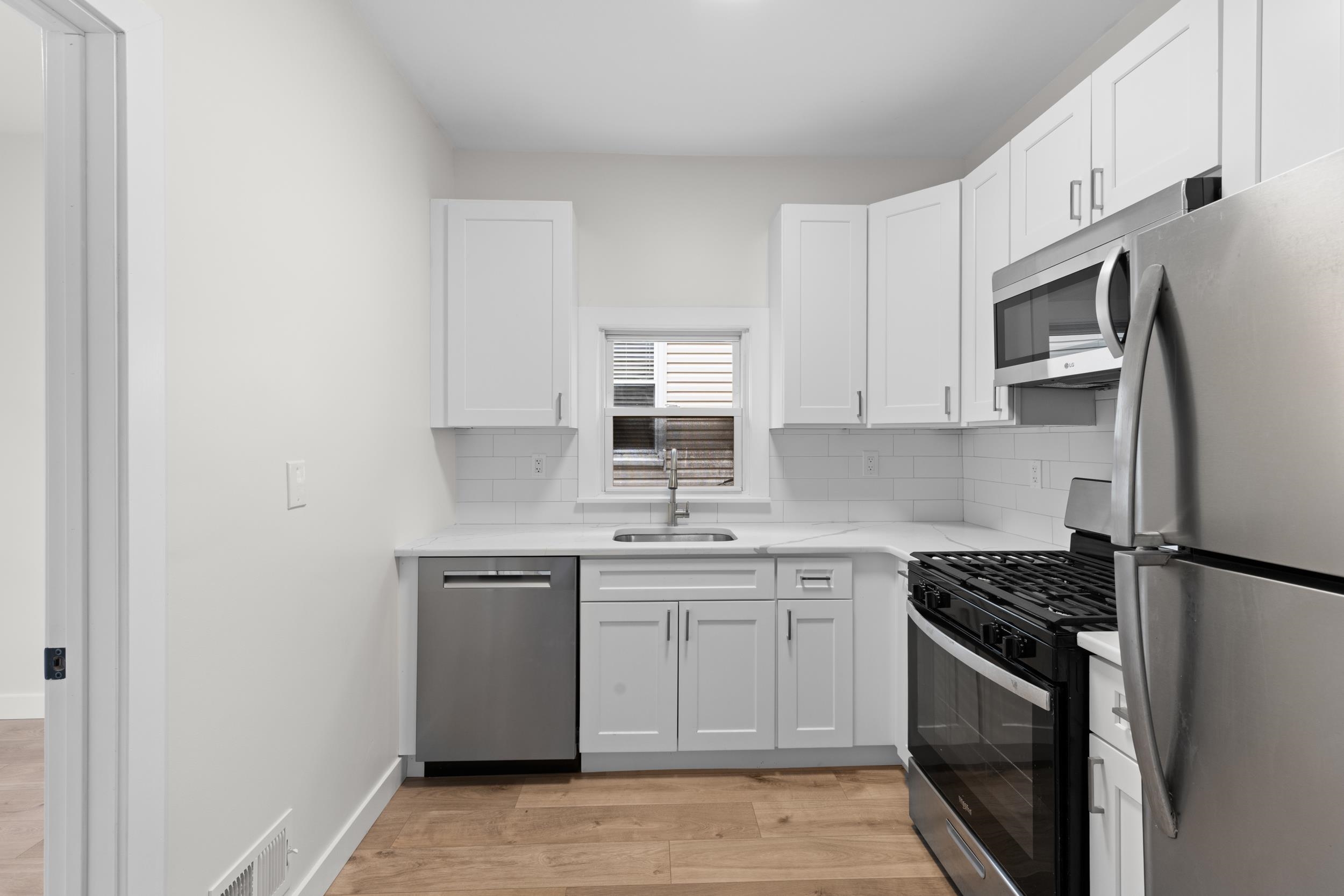 3 Edison Place, Unit 1 East Rutherford, NJ 07073 - Photo 10 of 21 a kitchen with stainless steel appliances granite countertop a sink stove and refrigerator