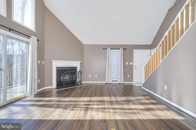 a kitchen with a white cabinets and wooden floor