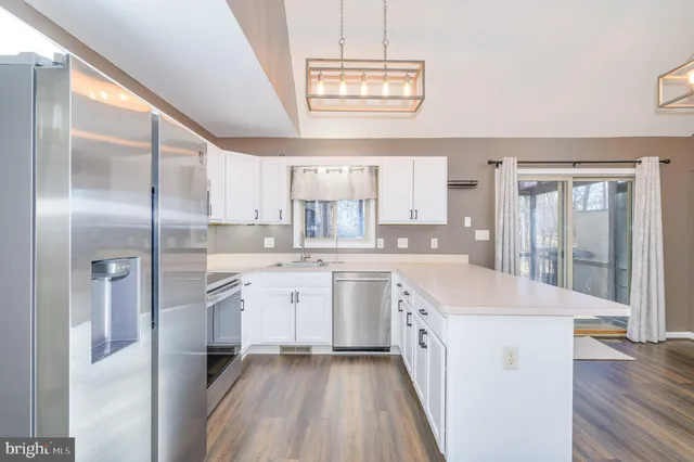 a large white kitchen with a large window