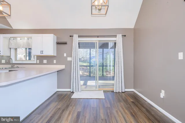 a view of a room with window and ceiling fan