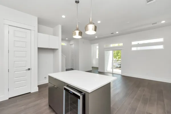 a kitchen with a wooden floor and window