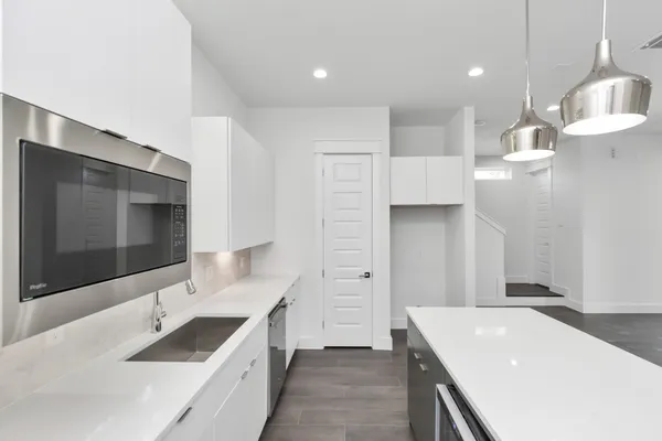 a kitchen with a sink stove and refrigerator