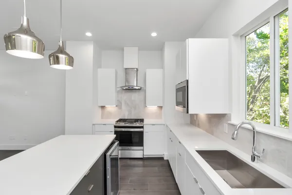 a kitchen with stainless steel appliances a sink stove and cabinets