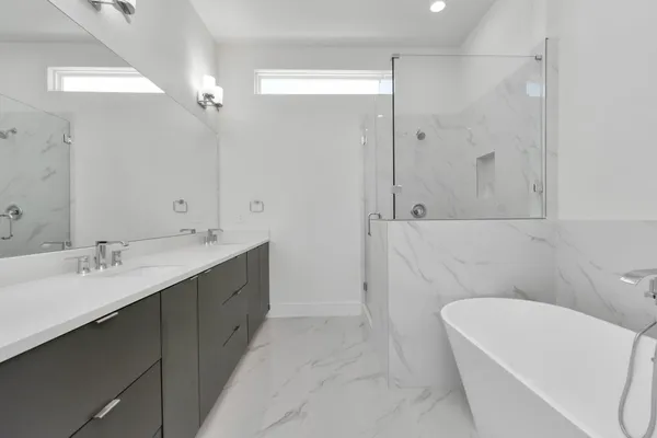 a bathroom with a tub sink and mirror