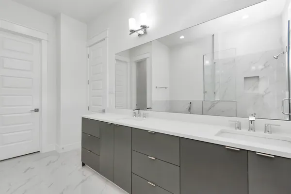 a bathroom with a double vanity sink and a mirror