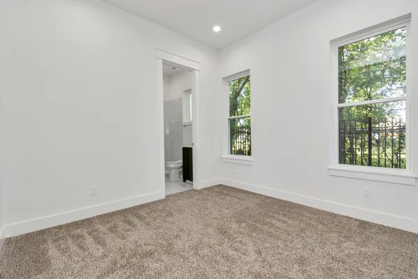 an empty room with windows and closet