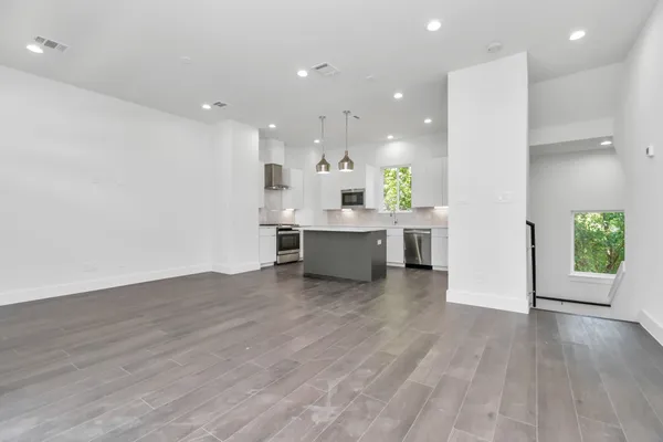 a view of kitchen with wooden floor and windows