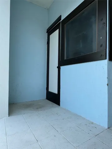 a view of a hallway with furniture and front door