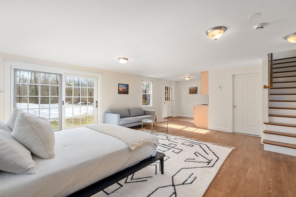 100 Oxford Road Westwood, MA 02090 - Photo 33 of 41 a bedroom with a bed and wooden floor