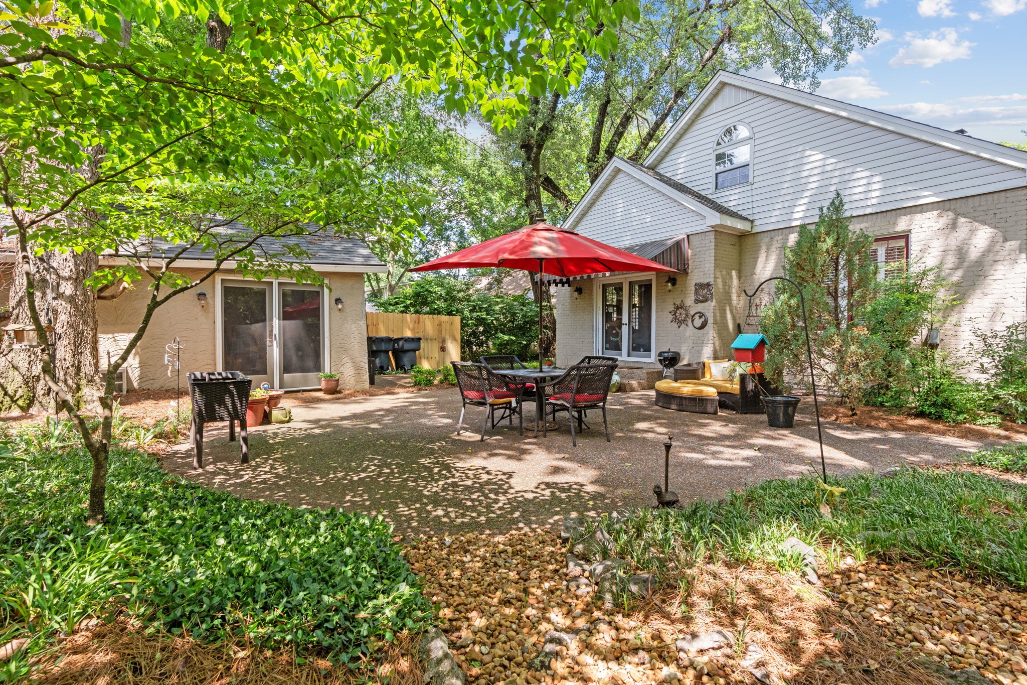 4117 Aberdeen Road Nashville, TN 37205 - Photo 42 of 46 a view of a patio with chairs and table under an umbrella