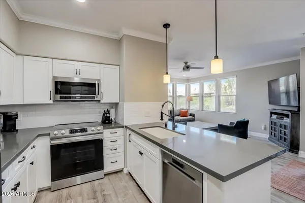 a kitchen with a stove a sink and a microwave