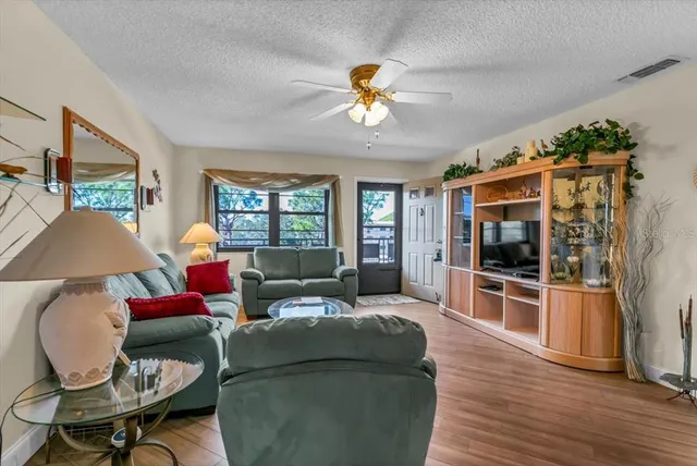 a living room with furniture a rug and a chandelier