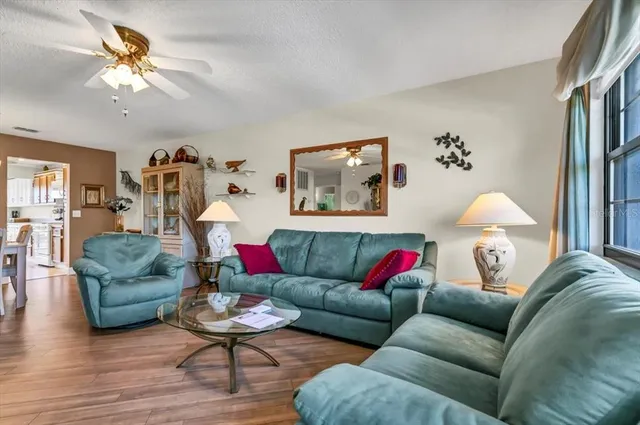 a dining room with wooden floor a chandelier a wooden table and chairs