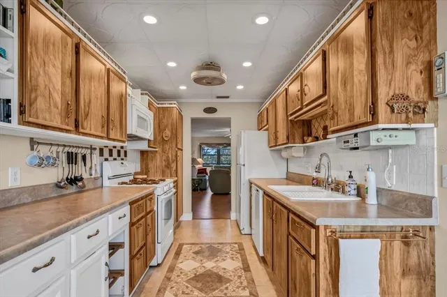 a kitchen with stainless steel appliances granite countertop a sink and cabinets