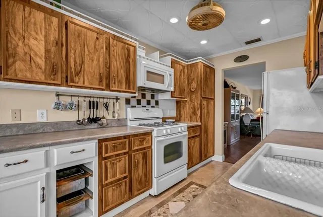 a kitchen with stainless steel appliances a refrigerator sink and cabinets