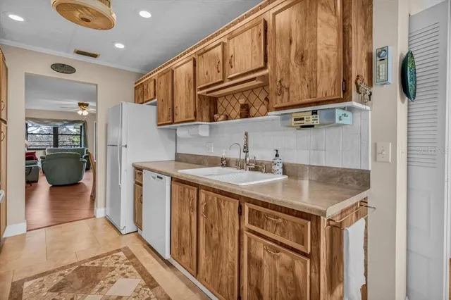 a kitchen with a table chairs and cabinets
