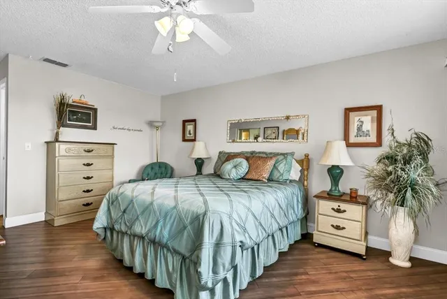 a bedroom with a large bed and a tv