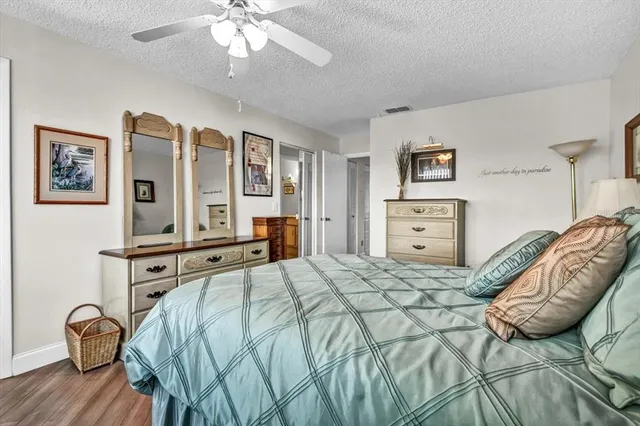 a bathroom with a granite countertop sink toilet and a mirror