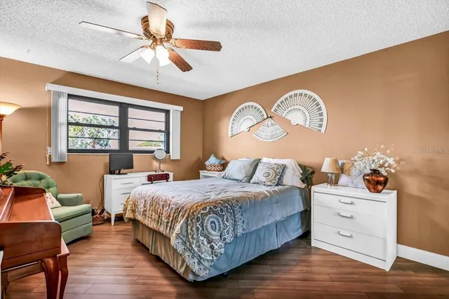 a bed room with a bed mirror and a chandelier