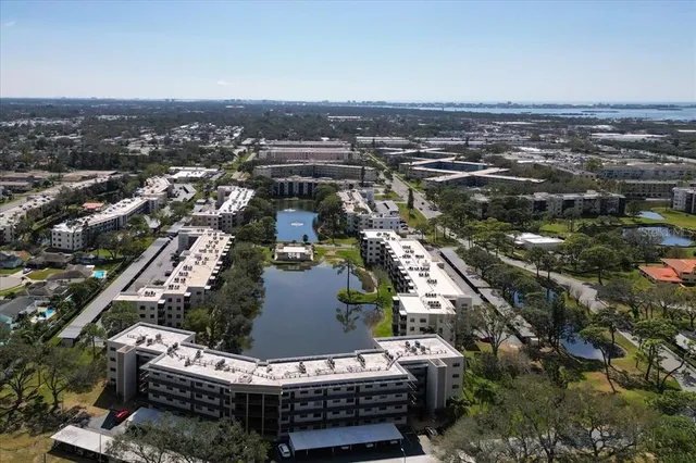 an aerial view of a house with a garden and swimming pool