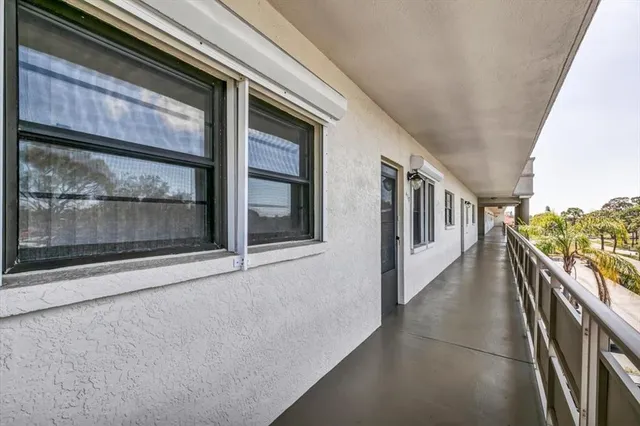 a view of a balcony with table and chairs