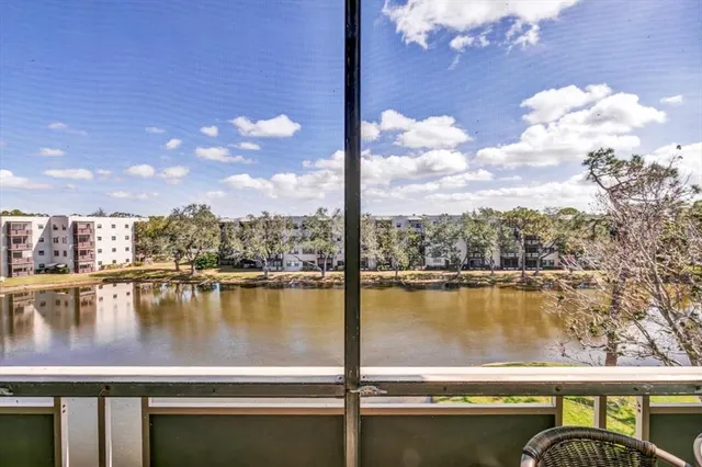 a view of a chairs and table in the balcony