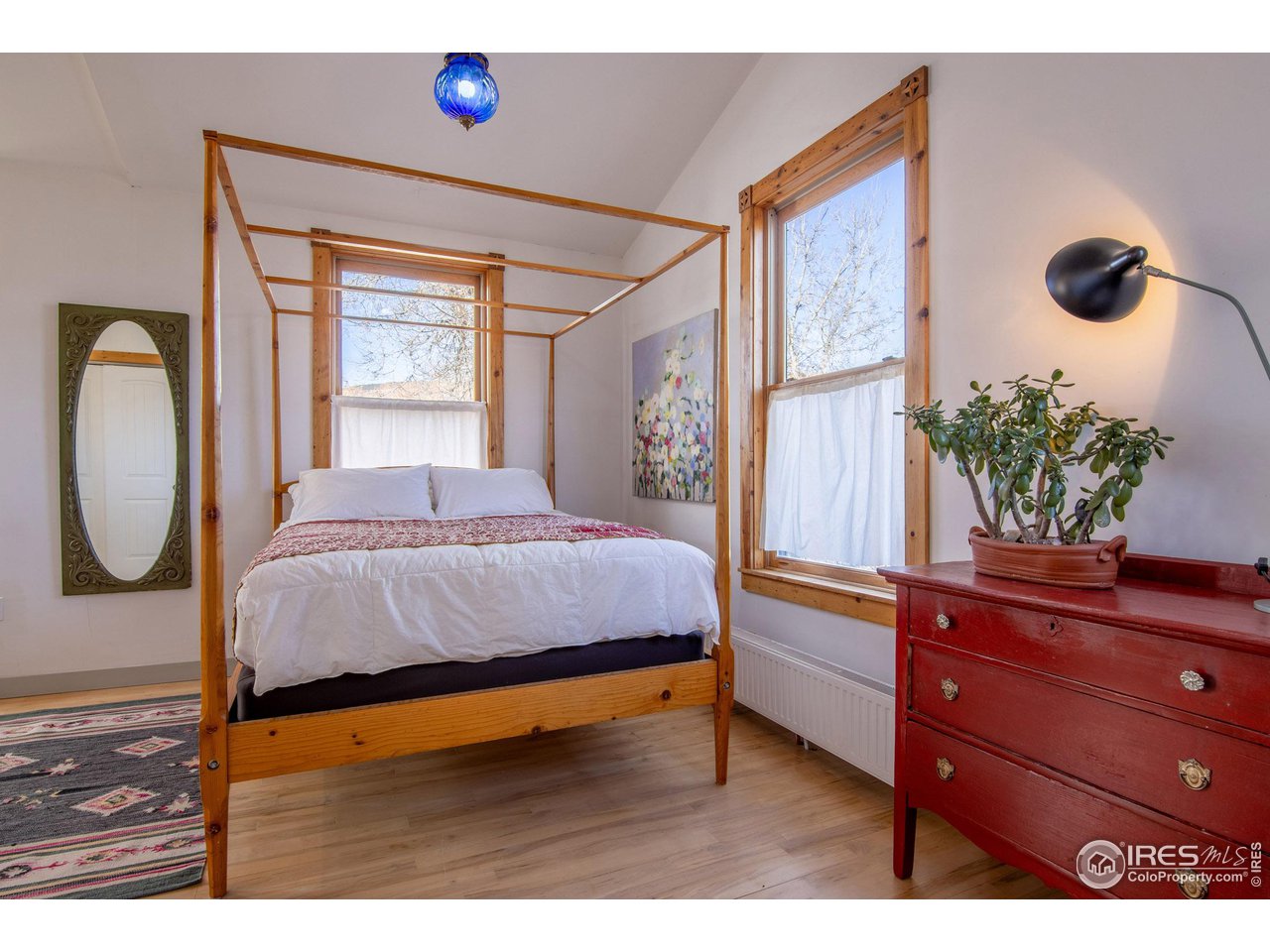 426 Park Street Lyons, CO 80540 - Photo 16 of 40 a bedroom with a bed and a potted plant on the dresser