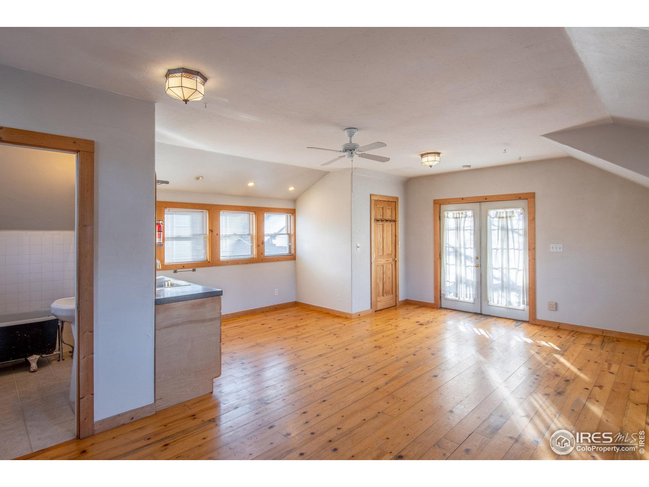 426 Park Street Lyons, CO 80540 - Photo 32 of 40 a view of an empty room with window and wooden floor