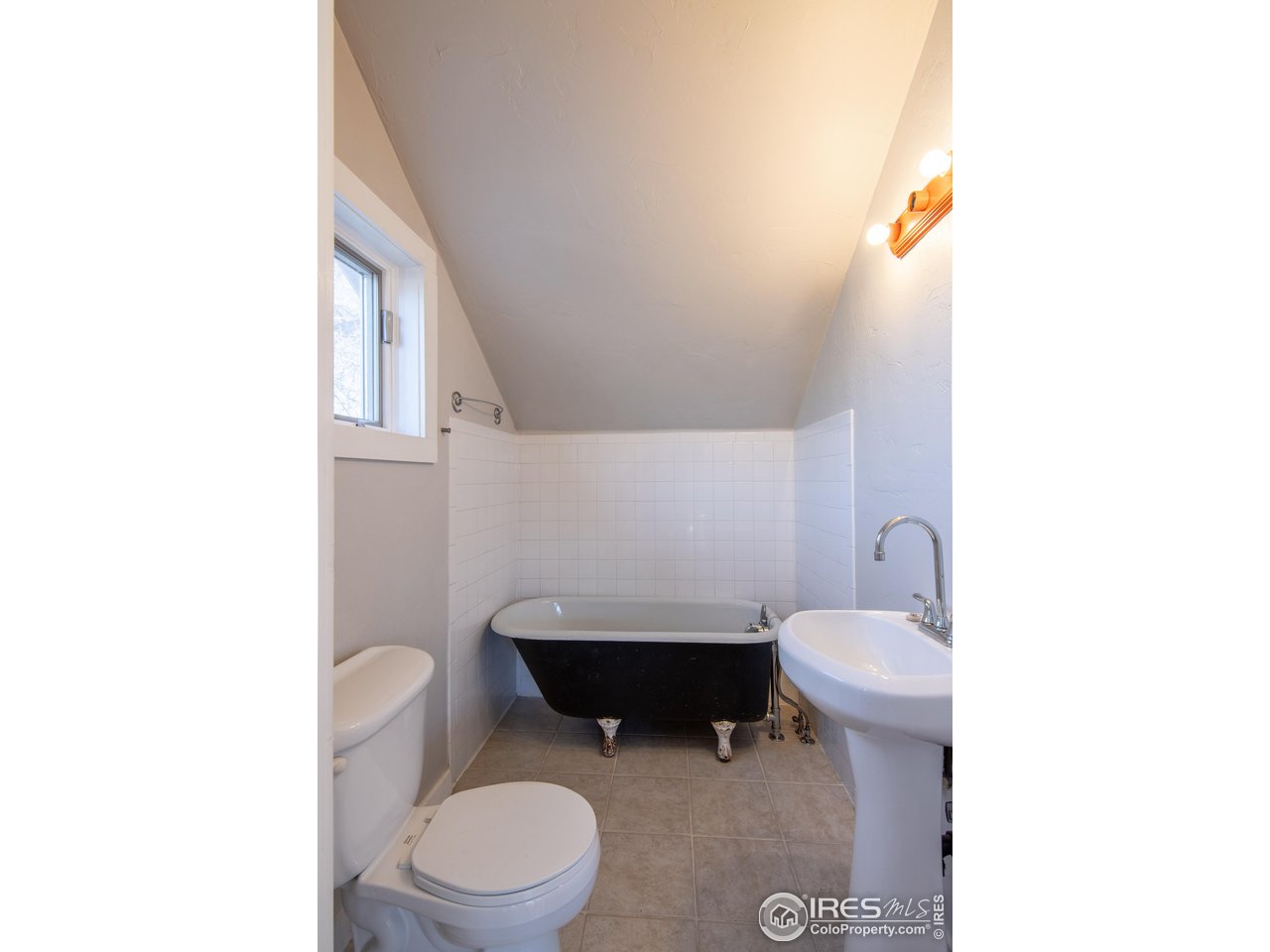426 Park Street Lyons, CO 80540 - Photo 33 of 40 a bathroom with a toilet a sink and a mirror