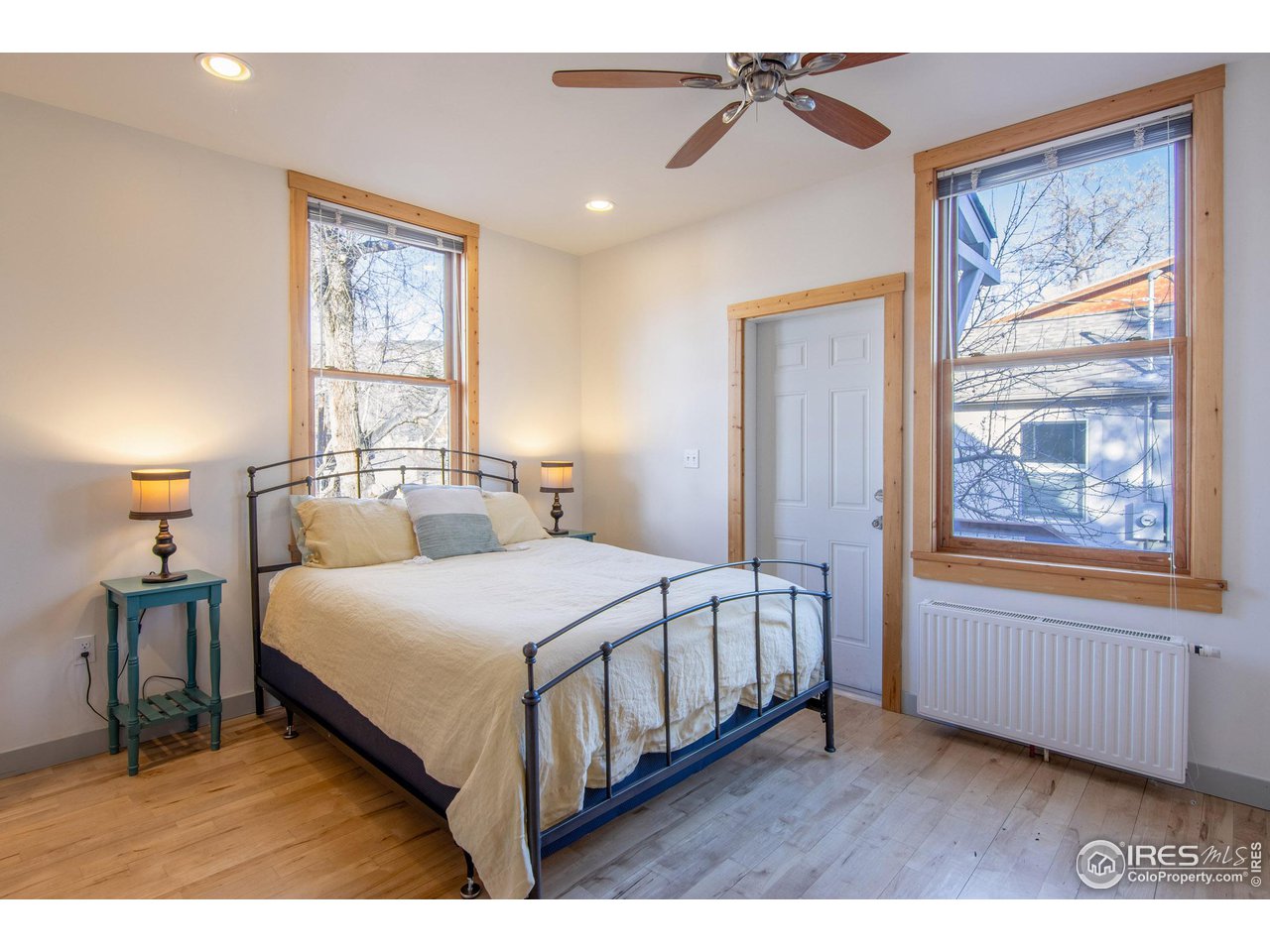 426 Park Street Lyons, CO 80540 - Photo 10 of 40 a bedroom with a bed a window and painting on the wall