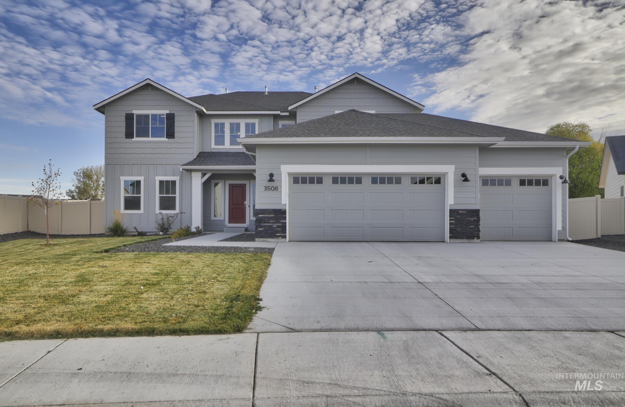 Contemporary two-story residence featuring light gray siding and a dark shingle roof