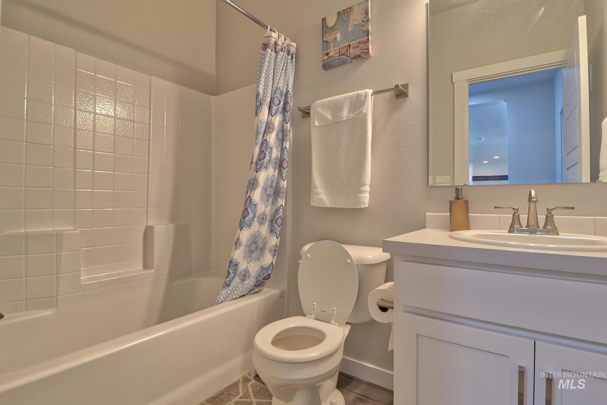 3508 South Edge Rim Way Meridian, ID 83642 - Photo 13 of 28 Bathroom featuring a white vanity with shaker-style cabinetry, a drop-in sink with a chrome faucet, and a large mirror