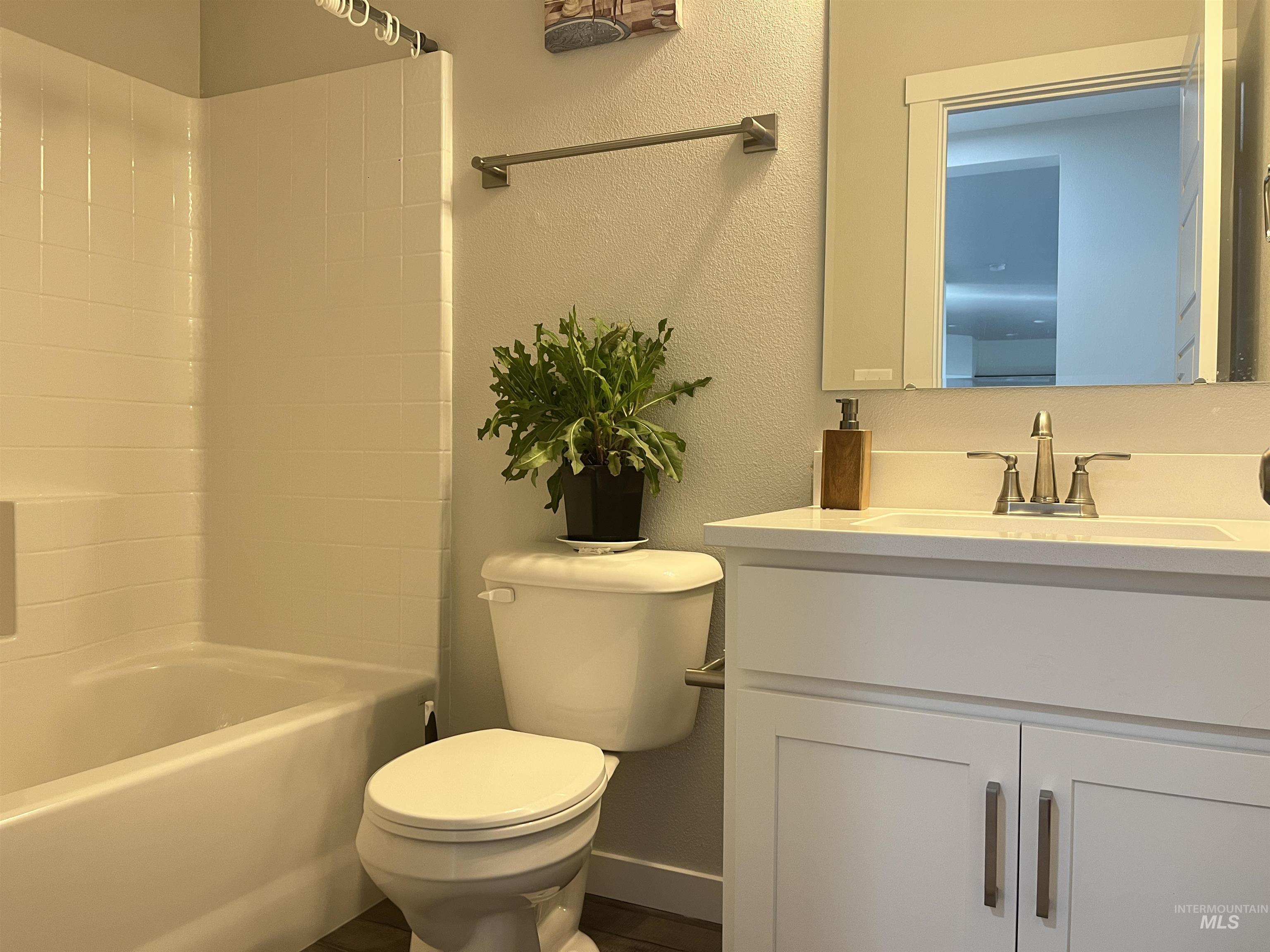 3508 South Edge Rim Way Meridian, ID 83642 - Photo 14 of 28 Bathroom featuring a white vanity with shaker-style cabinetry, a white countertop with an integrated sink, and a brushed nickel faucet