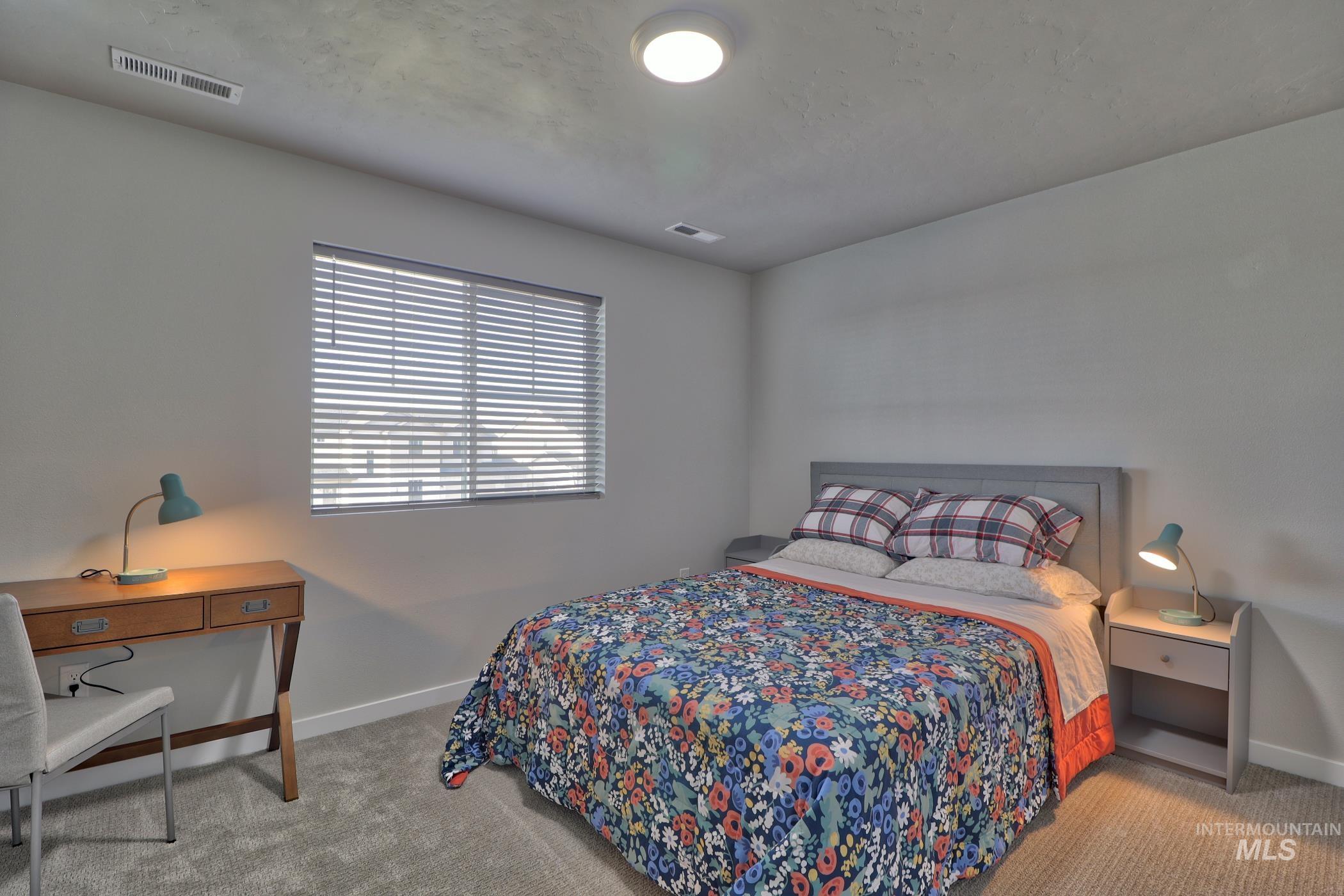 3508 South Edge Rim Way Meridian, ID 83642 - Photo 15 of 28 Bedroom featuring a window with horizontal blinds, light gray wall paint, and gray carpet flooring