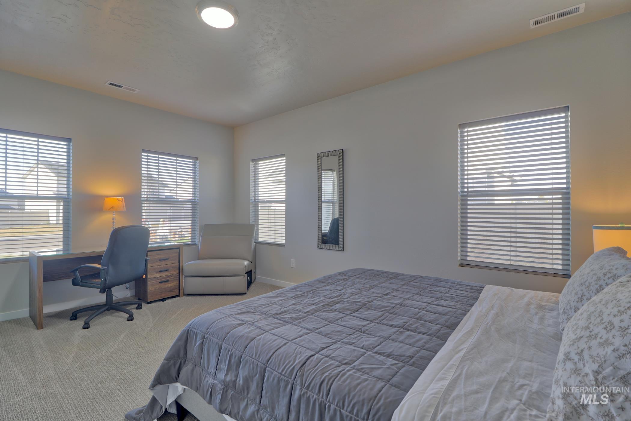 3508 South Edge Rim Way Meridian, ID 83642 - Photo 21 of 28 Carpeted room with multiple windows featuring horizontal blinds